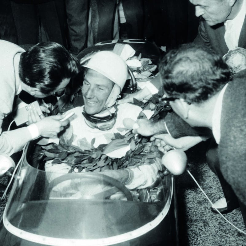 Stirling-Moss-in-his-car-surrounded-by-reporters-after-winning-the-1961-Monaco-Grand-Prix