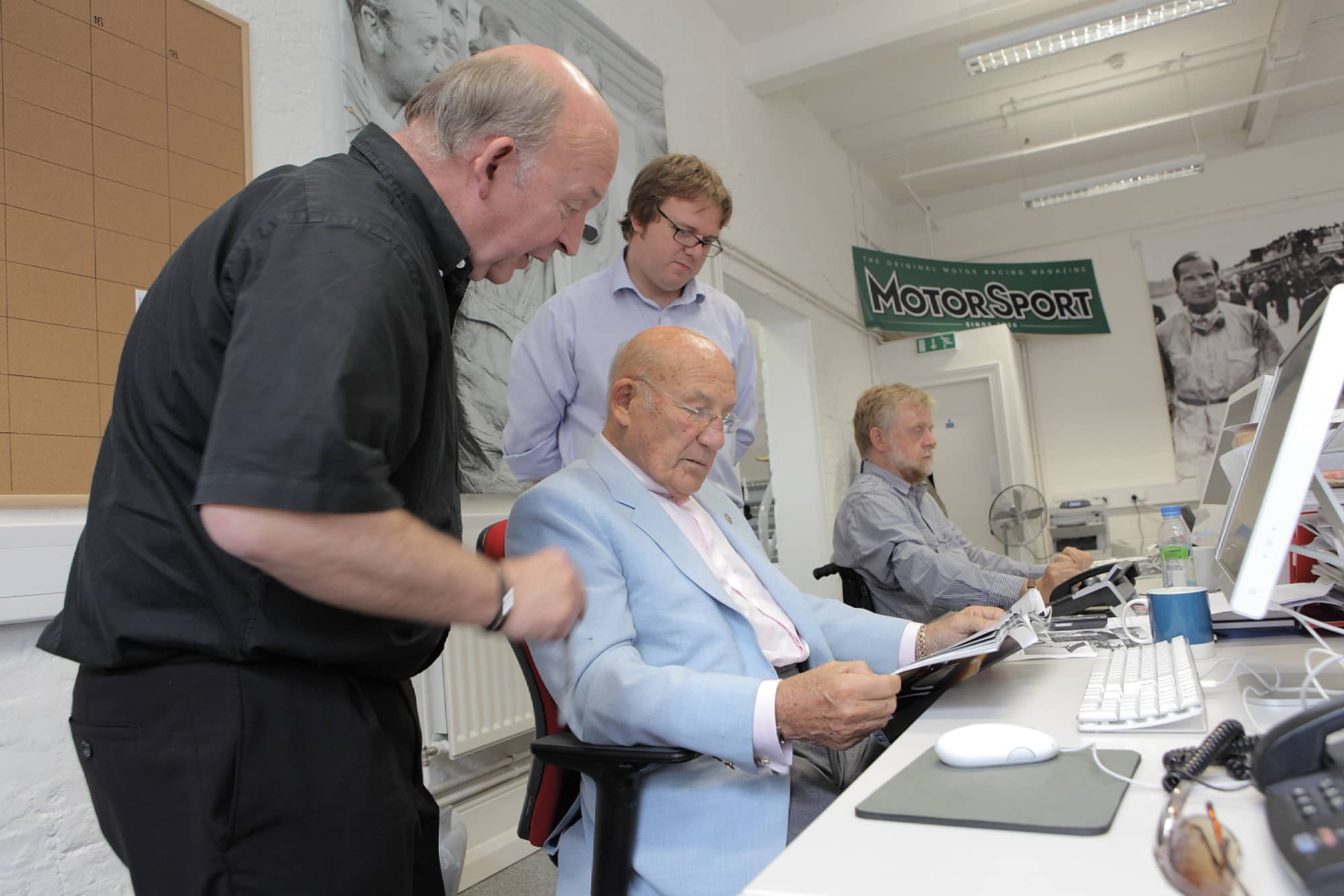 Stirling Moss in the Motor Sport editors chair