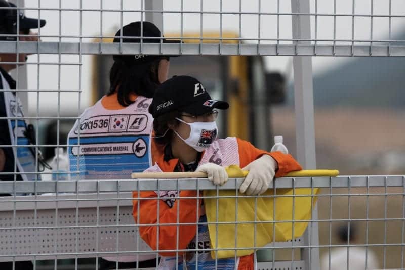 An F1 marshal wearing a face mask