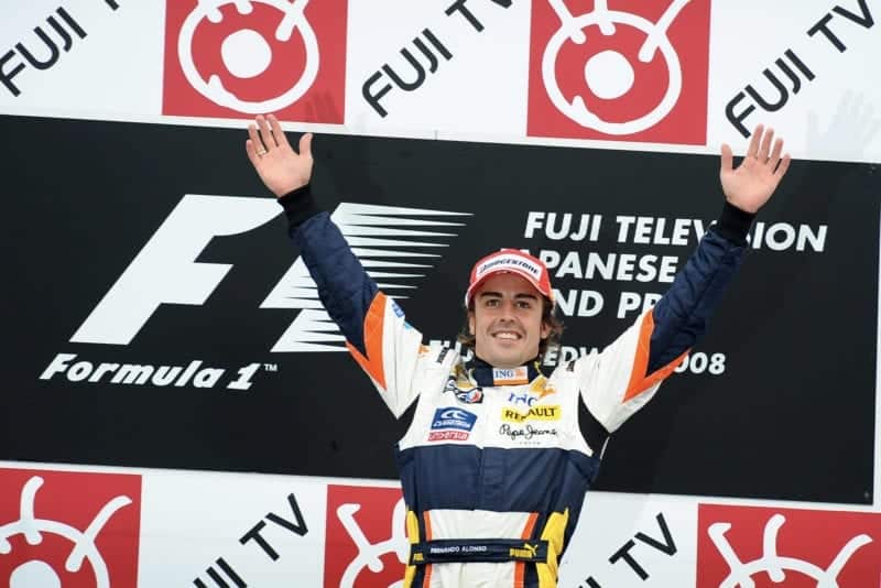 Fernando Alonso celebrates victory on the podium at the 2008 Japanese Grand Prix