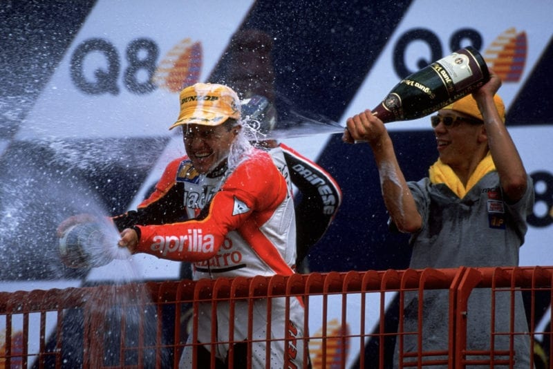 Valentino Rossi in beach gear on the podium at Mugello in 1998