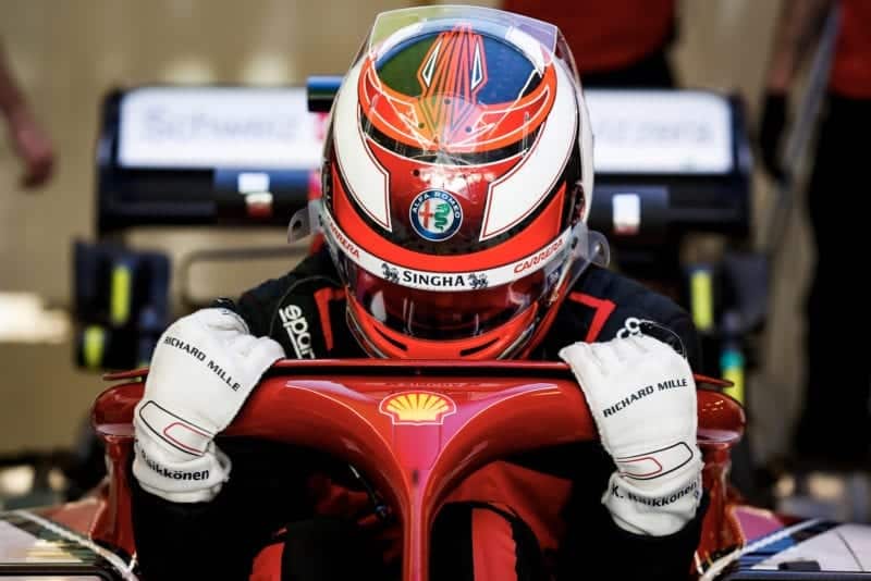 Kimi Raikkonen lowers himself into his Alfa Romeo in 2019
