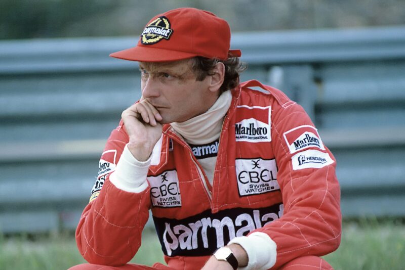 Niki Lauda at the side of the track resting his chin on his hand at the 1982 Dutch Grand Prix