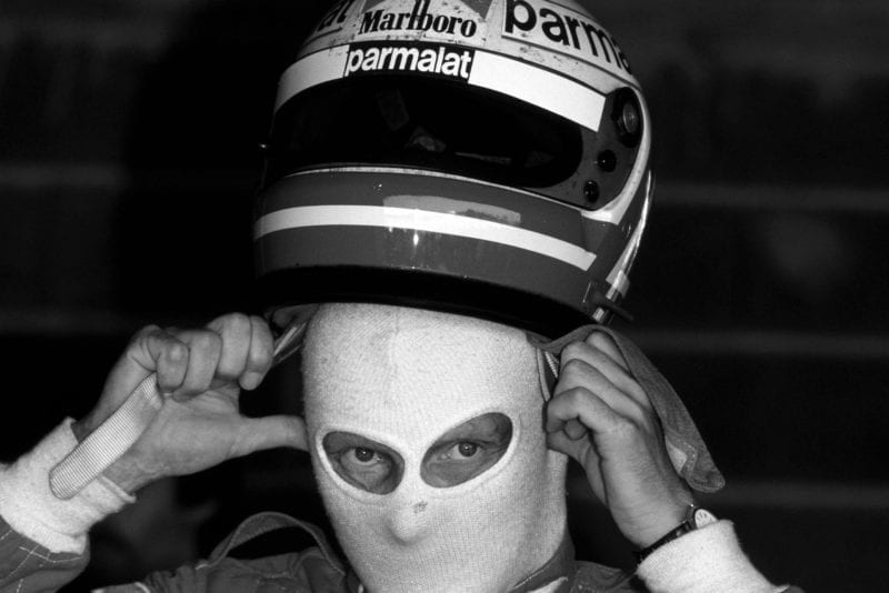 Niki Lauda pulls his helmet over his balaclava ahead of the 1982 Swiss Grand Prix