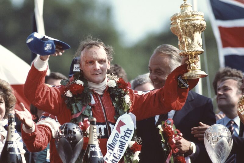 Niki Lauda holds up the winning trophy from the 1982 British Grand Prix at Brands Hatch