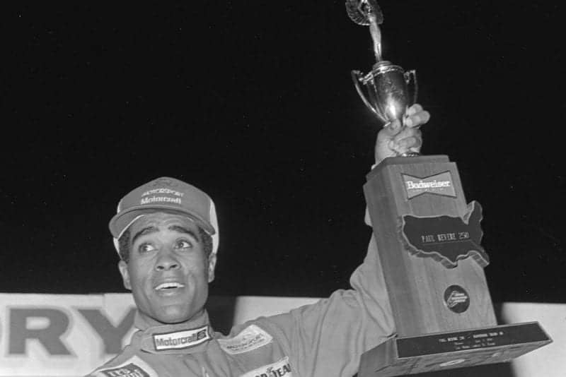 Willy T Ribbs holds the winning trophy at the 1984 Paul Revere 250 SCCA Trans Am Race at Daytona