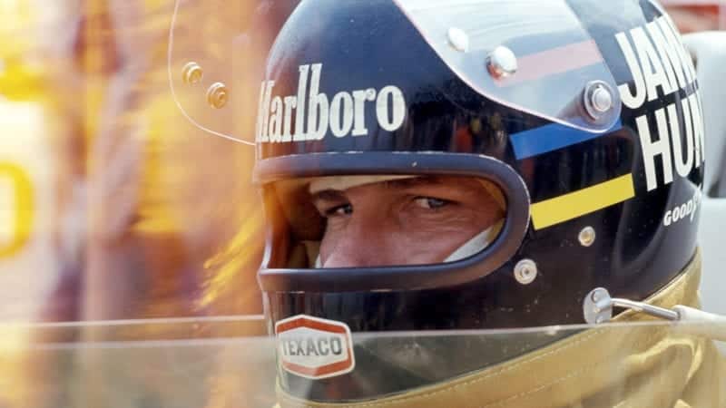 James Hunt stares out from behind his helmet while sat in the copckpit at Brands Hatch for the 1976 Formula 1 British Grand Prix