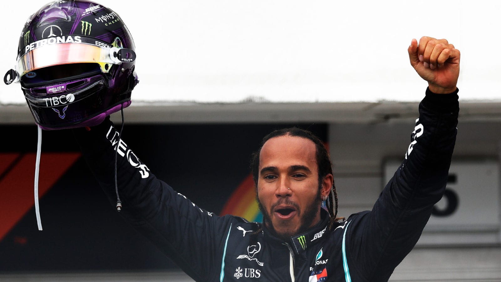 Lewis Hamilton throws his arms in the air after winning the 2020 F1 Hungarian Grand Prix