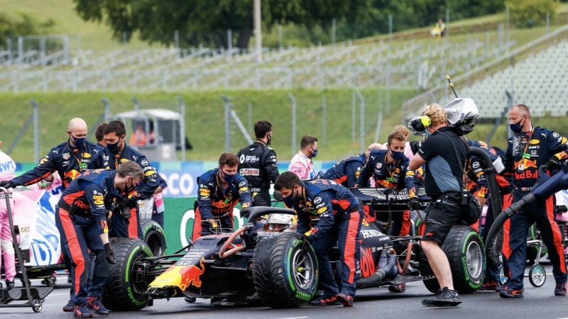 Max Verstappen arrives to the grid of the 2020 f1 Hungarian Grand Prix with a damaged nose after crashing