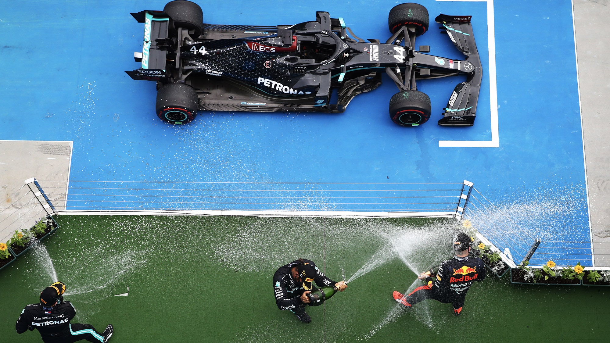 Overhead view of champagne spraying on the podium and Lewis Hamilton's winning Mercedes after the 2020 Formula 1 Hungarian Grand Prix