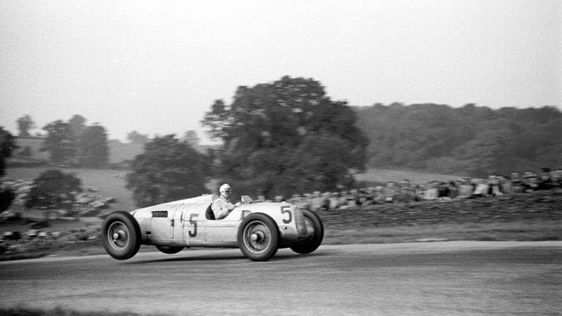 The back wheels of Bernd Rosemeyer's Auto Union lidt in the air over Melbourne Rise during the 1937 Donington Park Grand Prix