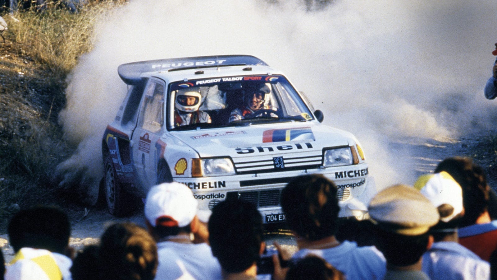 Timo Salonen drives through a water splash in his Peugeot 205 T16 in the 1986 Sanremo Rally
