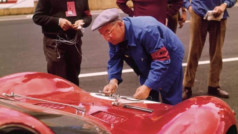 A scrutineer examining a Ferrari at Le Mans