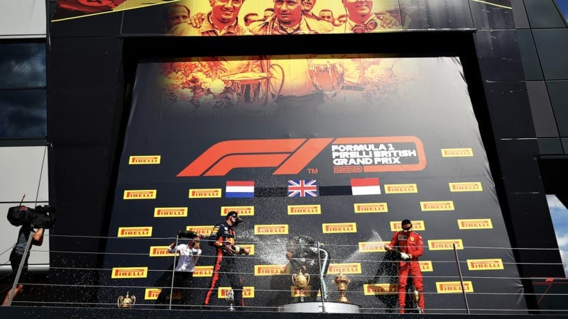 British GP podium celebrations withe Lewis Hamilton Max Verstappen and Charles Leclerc spraying champagne