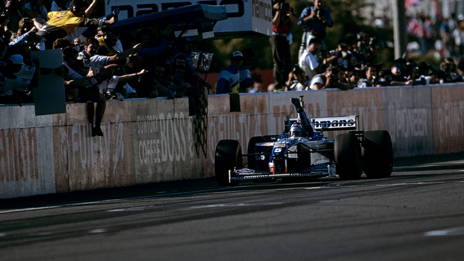Damon Hill crosses the finish line at the 1996 Japanese Grand Prix at Suzuka to claim the Formula 1 Drivers Wold Championship