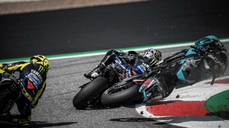 Franco Morbidelli's bike flies through the air between Maverick Vinales and Valentino Rossi after a crach at the Red Bull Ring in the 2020 MotoGP Austrian Grand Prix