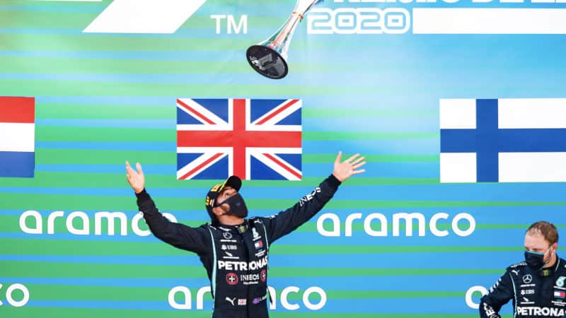 Hamilton throws trophy in the air
