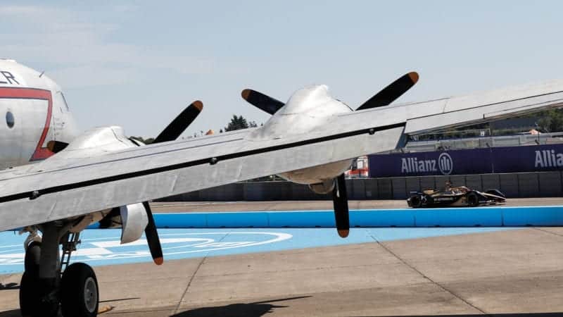 Jean Eric Vergne drives in front of an aeroplane at VBerlin Tempelhof airport during the final races of the 2019-20 Formula E championship