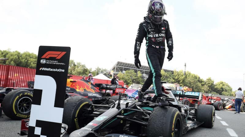 Lewis Hamilton leaps out of his MErcedes W11 after winning the 2020 F1 Spanish Grand Prix