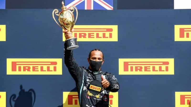 Lewis Hamilton lifts the F1 British Grand Prix winner's trophy after the 2020 Silverstone race