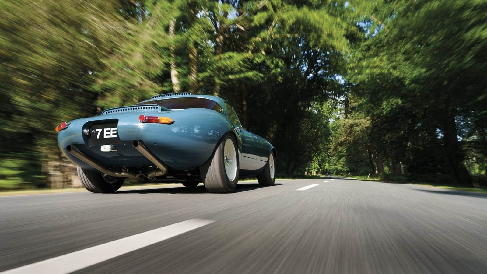 Rear shot of the 2020 Eagle E-type Lightweight GT and its exhaust pipes ona. country road
