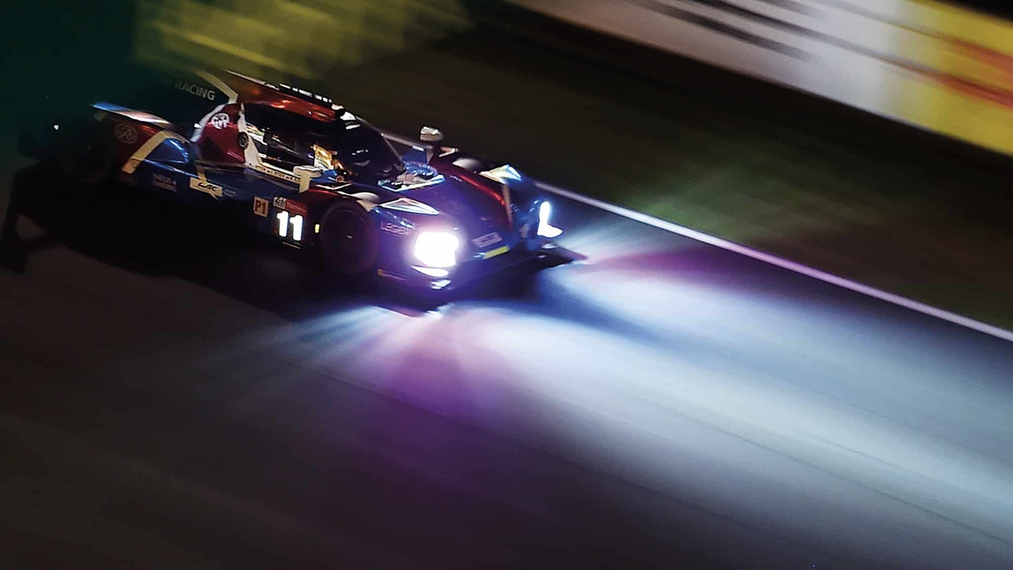 SMP Racing's headlights illuminate the track at night during the Le Mans 24 Hours
