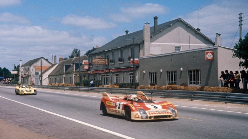The Juan Fernandez Bernard Cheneviere and Francisco Torredemer Porsche 908 drives past the Hotel Les Hunaudieres in the 1973 Le Mans 24 hours