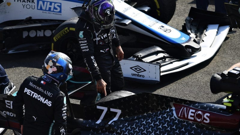 Valtteri Bottas and Lewis Hamilton examine the tyre damage to Bottas' Mercedes at the end of the 2020 F1 70th Anniversary Grand Prix