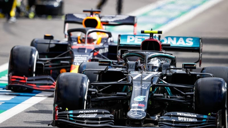 Valtteri Bottas leaves the Spa Francorchamps pits ahead of Max Verstappen during the 2020 f1 Belgian Grand prix