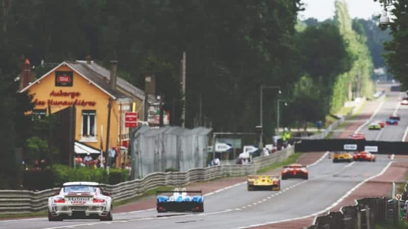 Cars race past the Auberge de Hunaudiere on the Mulsanne Straight duting the 2007 Le Mans 24 Hours