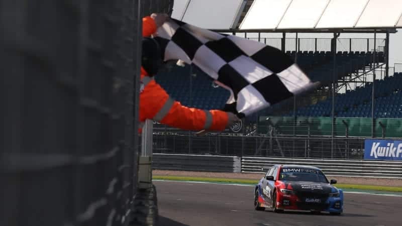 Colin Turkington takes the chequered flag at Silverstone in the 2020 BTCC meeting