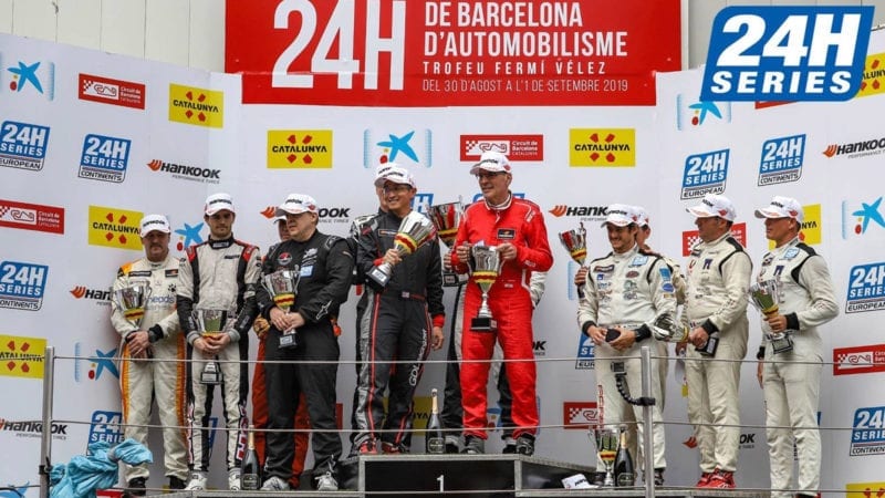 Dominique Bastien holds his trophy on the podium for winning his class in the 2019 24 Hours of Barcelona