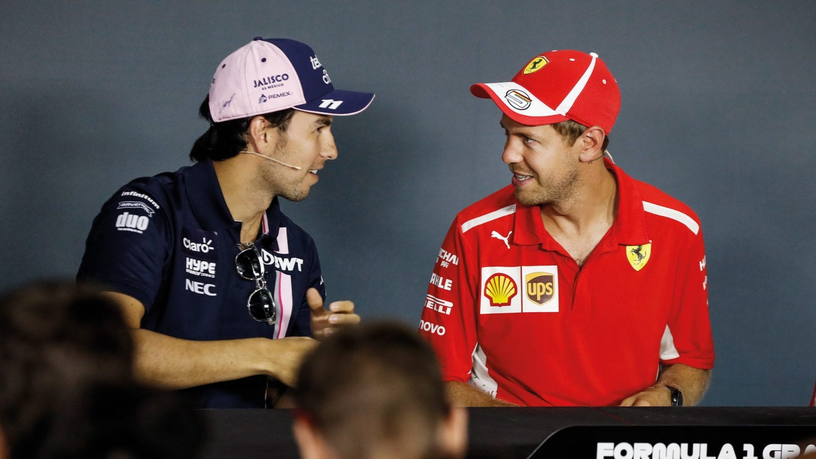 Sergio Perez and Sebastian Vettel talk during a Formula 1 press conference