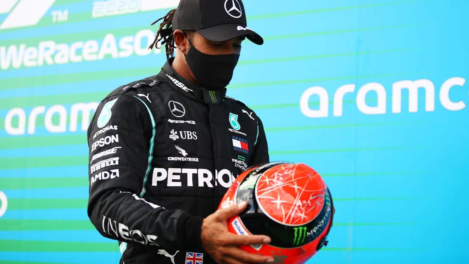 Lewis Hamilton holds one of Michael Schumacher's helmets presented to him after equalling the 91 F1 win record at the 2020 Eifel Grand Prix at the Nurburgring