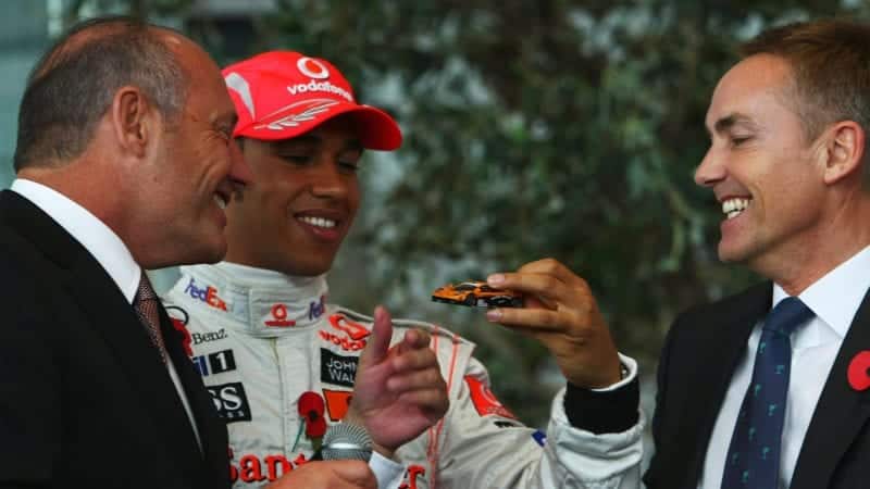 Lewis Hamilton is presented with a McLaren F1 model by Ron Dennis and Martin Whitmarsh in 2008