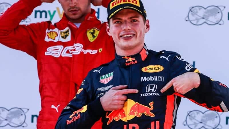 Max Verstappen points at his Honda badge after winning the 2019 F1 Austrian Grand Prix