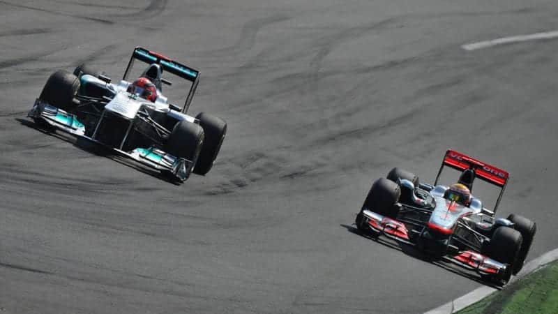 Michael Schumacher and Lewis Hamilton side by side at Monza during the 2011 Italian Grand Prix