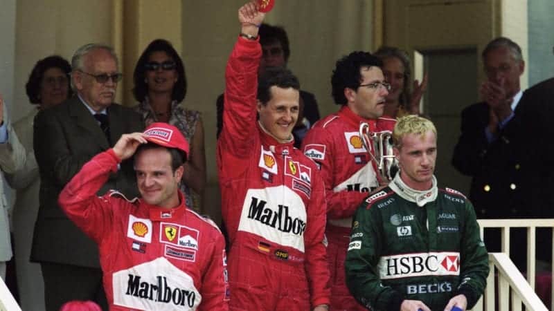 Michael Schumacher celebrates winning in Monaco alongside Rubens Barrichello and Eddie Irvine