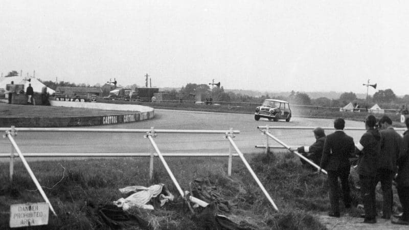 Mini Cooper at Copse Corner during the 1965 British Grand Prix meeting at Silverstone