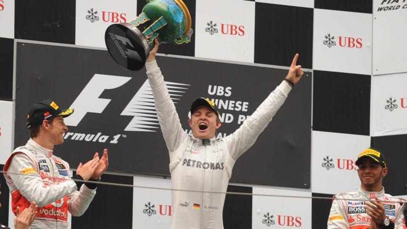 Nico Rosberg celebrates winning the Chinese Grand Prix with Jenson Button and Lewis Hamilton on the podium