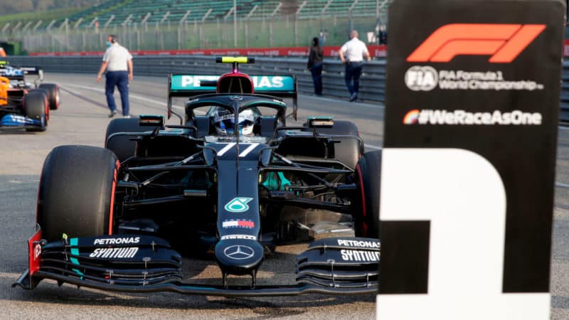 Valtteri Bottas parks his Mercedes in front of the. number 1 sign at imola after qualifying on pole for the 2020 F1 Emilia Romagna Grand Prix