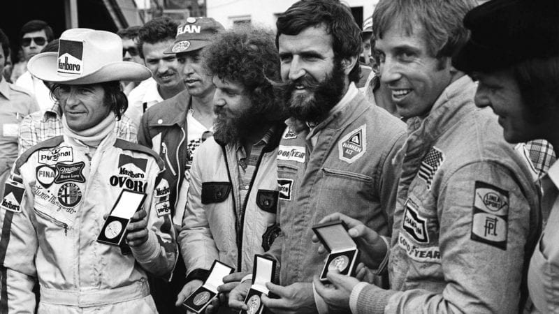 Arturo Merzario receives a medal for helping to save Niki Lauda's life along with a representative of Guy Edwards, Harald Ertl and Brett Lunger