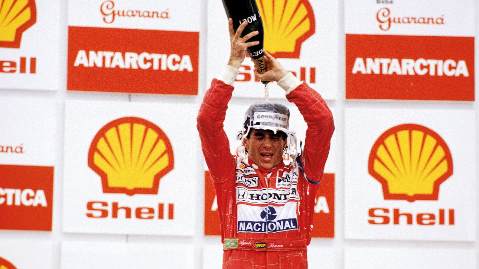 Ayrton Senna pours champagne over his head after winning the 1991 Brazilian Grand PRix at Interlagos for McLaren