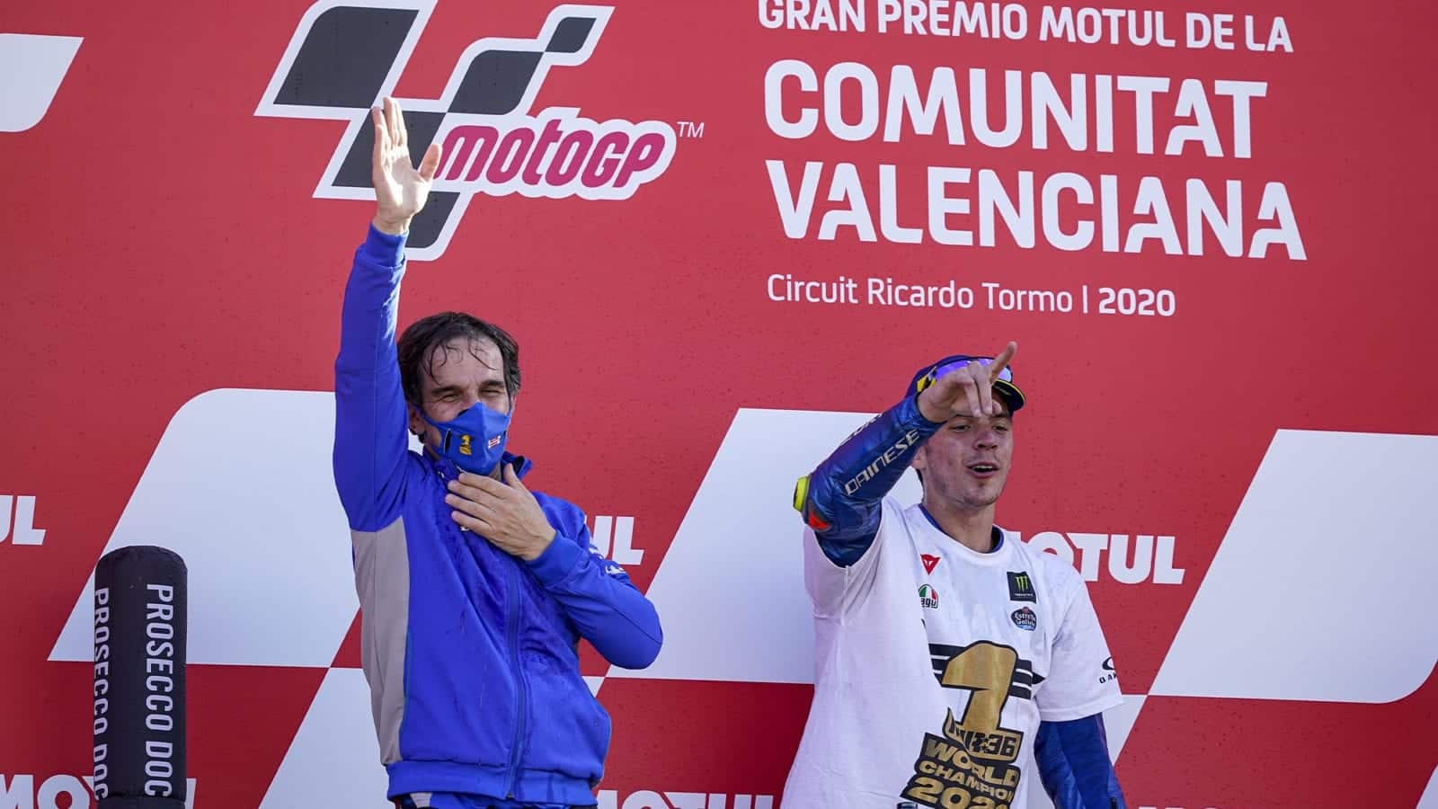 Joan Mir on the Valencia podium with Davide Brivio his team manager after winning the 2020 MotoGP World Championship