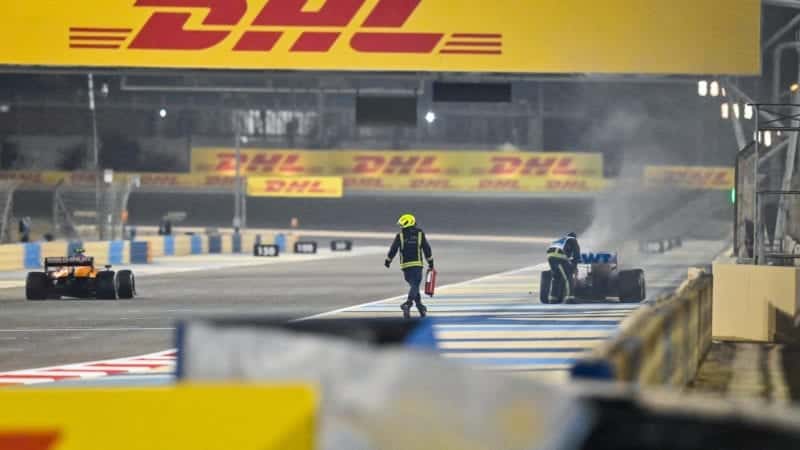 Lando Norris passes a marshal who had run across the track at the 2020 F1 Bahrain Grand Prix