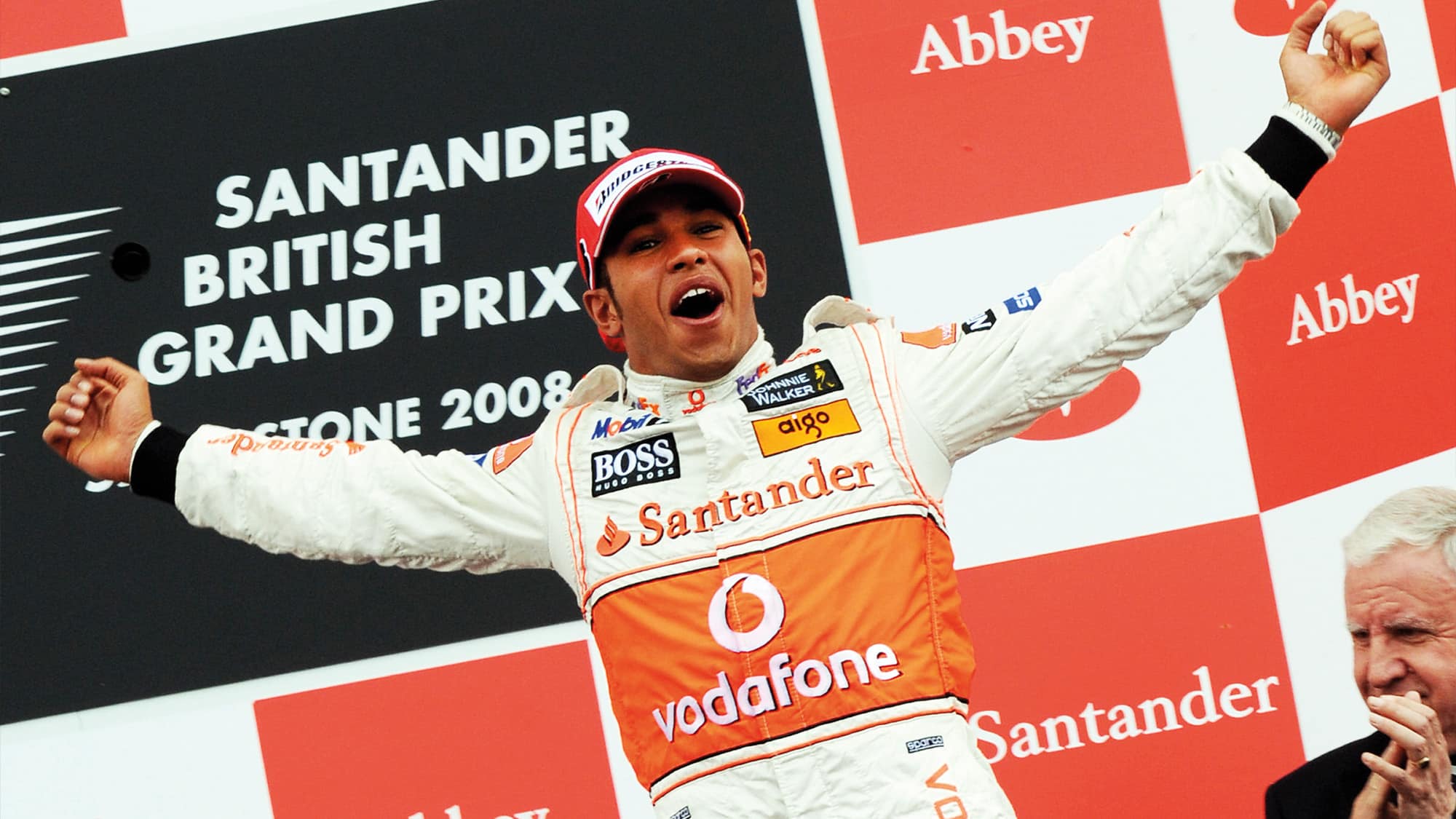 Lewis Hamilton on the podium after winning the 2008 F1 British Grand Prix with McLaren