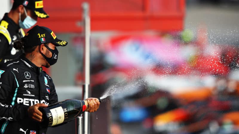 Lewis Hamilton sprays champagne on the Imola podium after the 2020 F1 emilia Romagna Grand Prix