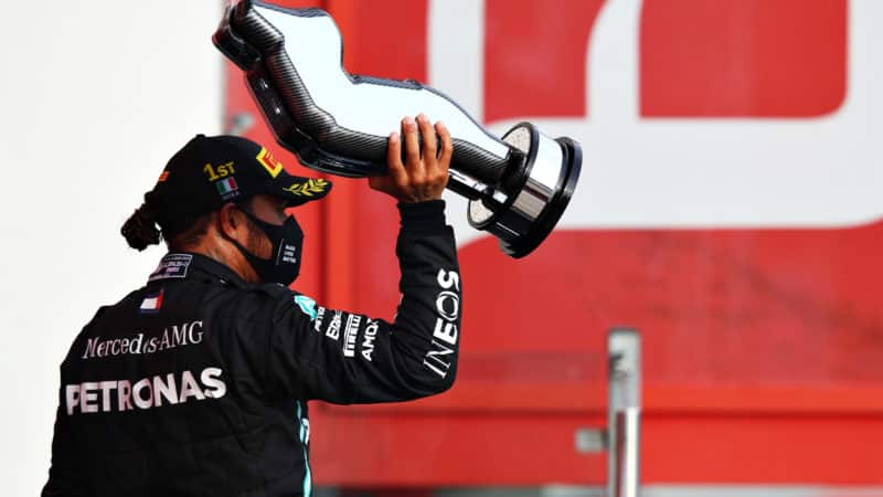 Lewis Hamilton stands with the winning trophy from the 2020 emilia romagna grand prix