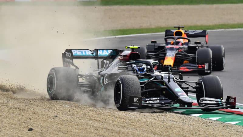 Mercedes of Valtteri Bottas runs wide at Imola as he's pursued by Max Verstappen's Red Bull during the 2020 F1 Emilia Romagna Grand prix