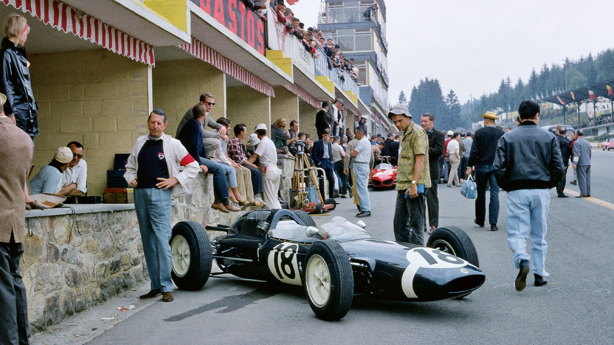 Rob Walker stands next to his Lotus 24 at Spa Francorchamps ahead of the 1962 Belgian Grand Prix